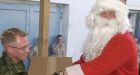 Soldiers don Santa hats, pine for home during early Xmas dinner in Kandahar