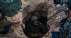 Israeli troops, with dogs and robots, track Gaza tunnels