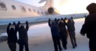 Russian airline passengers push frozen jet