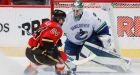 Flames burn Canucks in 4th straight loss