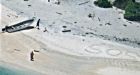 'SOS' in sand leads to rescue of 2 stranded on island in Micronesia