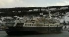 Derelict cruise ship under tow by offshore supply vessel