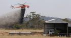 Australian wildfire destroys more than 100 homes along coast