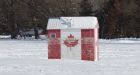 Manitoba fishing pair watch as trout nibble lures beneath crystal clear ice